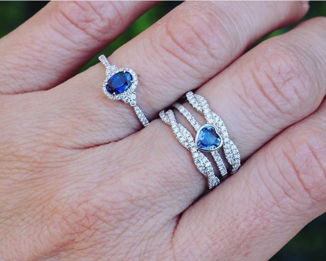 Image of sapphire and diamond engagement and wedding rings stacked. 