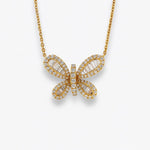 Baguette diamond butterfly on yellow gold. 
