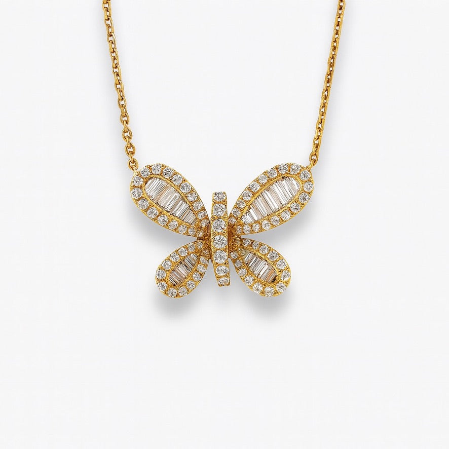 Baguette diamond butterfly on yellow gold. 