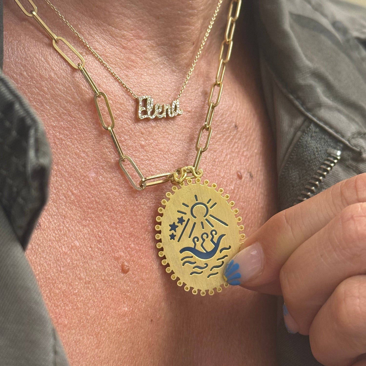 Close-up of agate medalla de la Caridad del Cobre gold plated Cuban jewelry