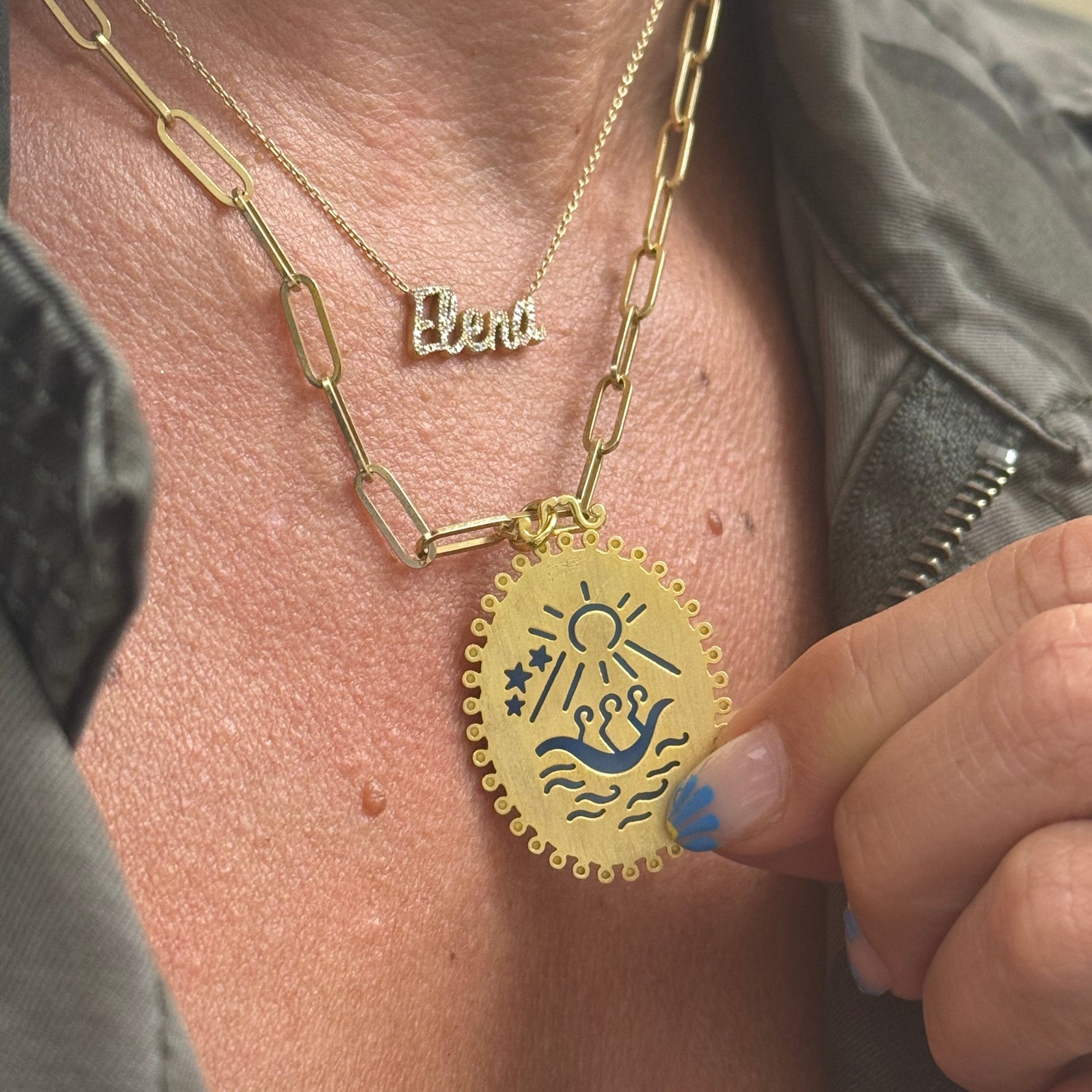 Close-up of agate medalla de la Caridad del Cobre gold plated Cuban jewelry