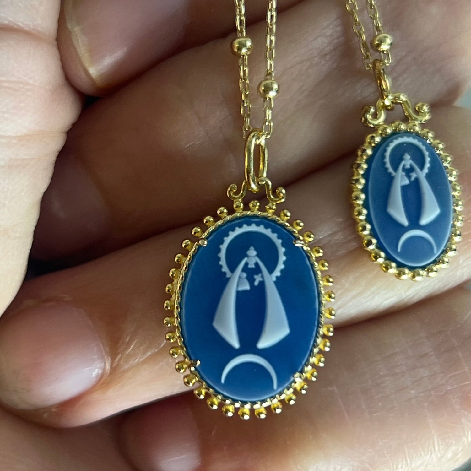 Sterling silver and gold plating pendant necklace with a blue agate image of La Caridad del Cobre, the patron saint of Cuba.