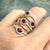 Ruby and diamond halo ring in 14K yellow gold, available at Santayana Jewelers Miami