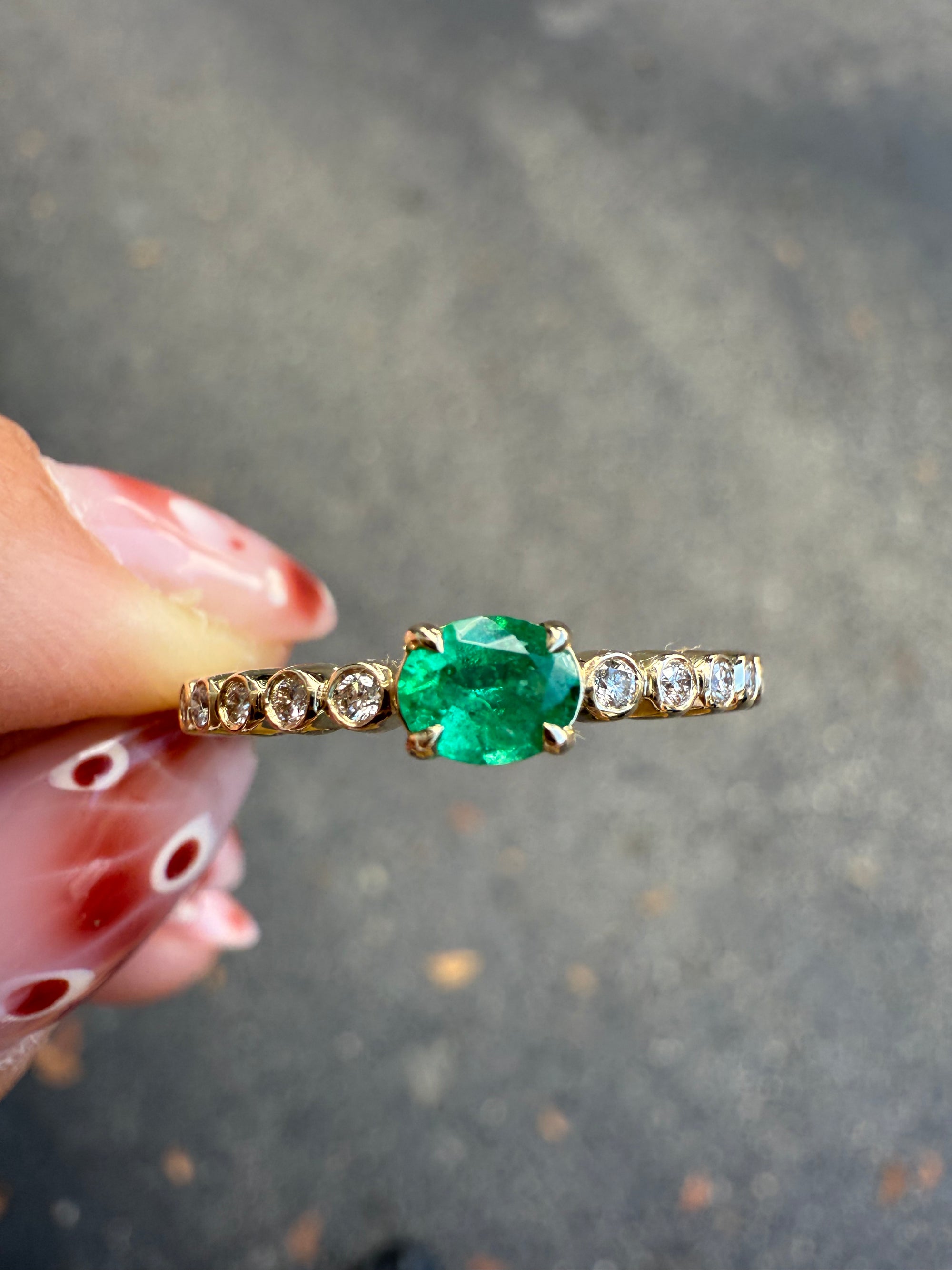 Close-up of petite emerald and diamond stacking ring in 14K yellow gold, Santayana Jewelers Miami