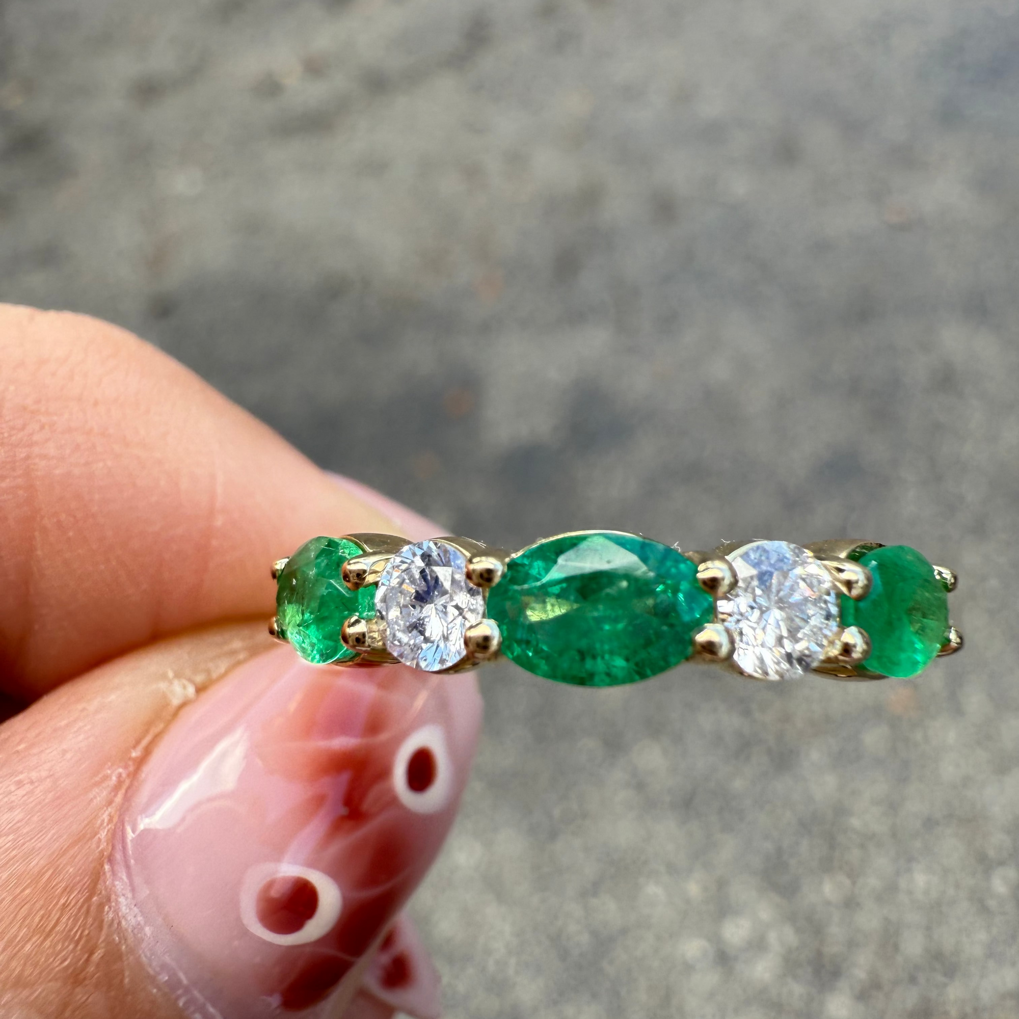 Top view of Emerald and diamond five-stone ring in 14K yellow gold.